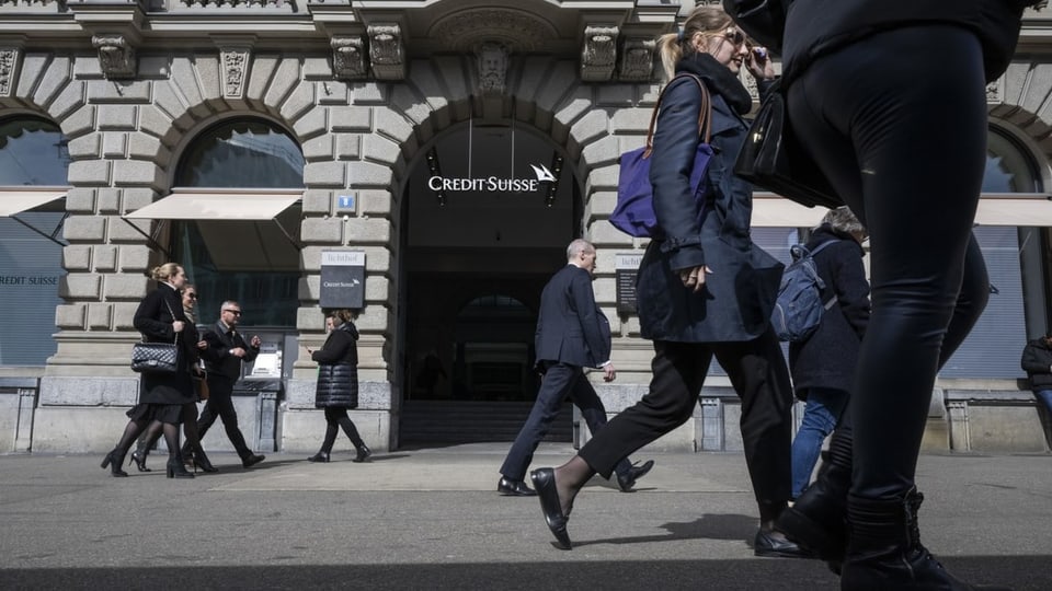 Ein Mann läuft an einem Gebäude mit einem Credit Suisse Logo vorbei