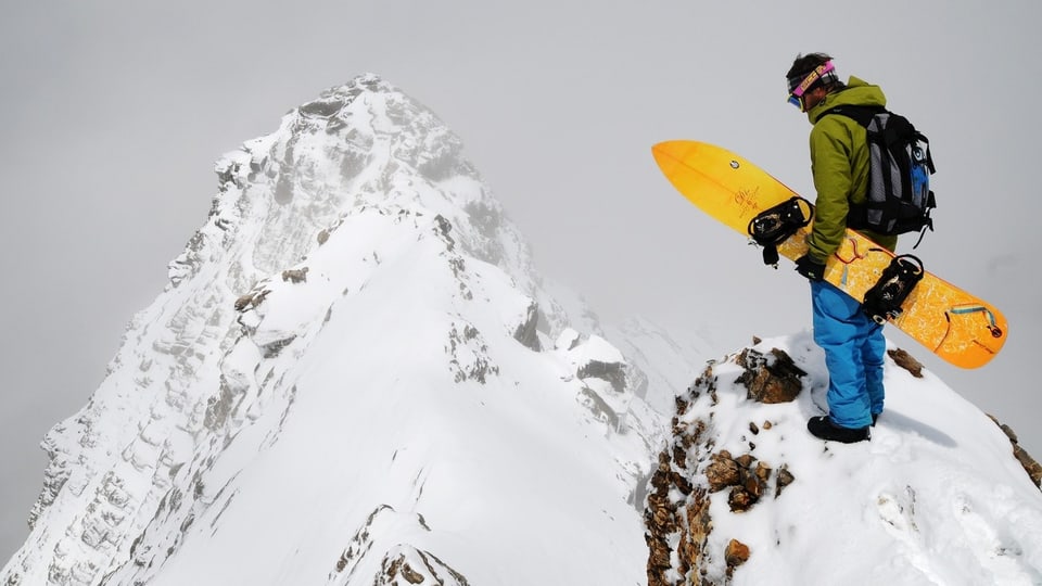 Snowboarder schaut von Gipfel runter