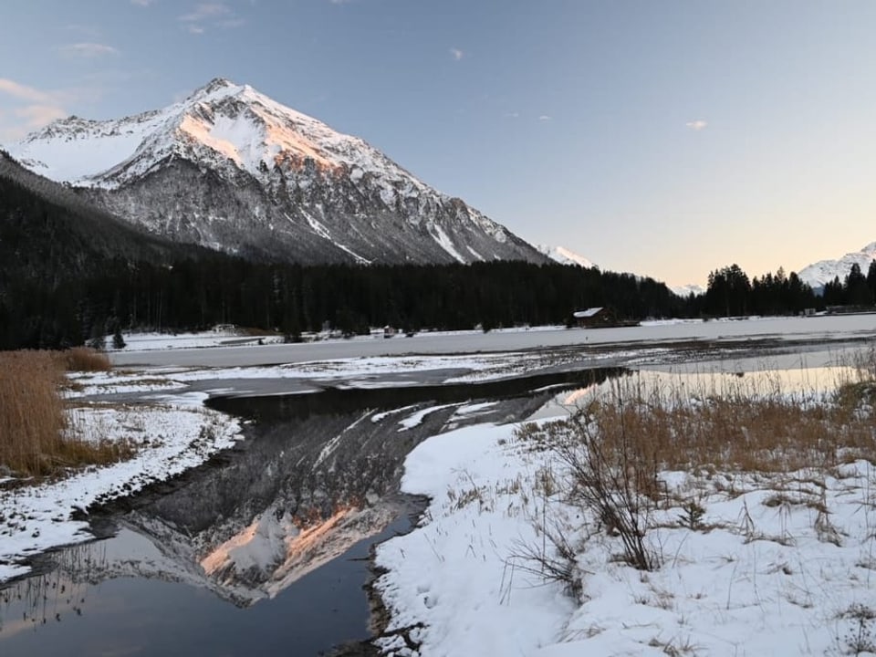 Das Lenzerhorn spiegelt sich im See.