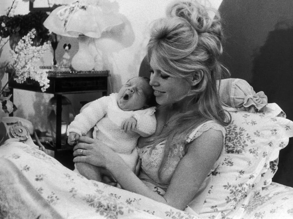 Brigitte Bardot im Bett liegend mit ihrem neugeborenen Sohn Nicolas.