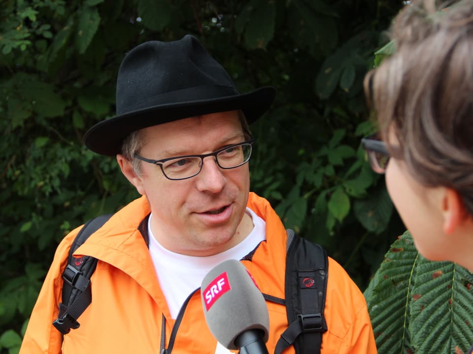 Mundartexperte Markus Gasser mit Hut wird interviewt.