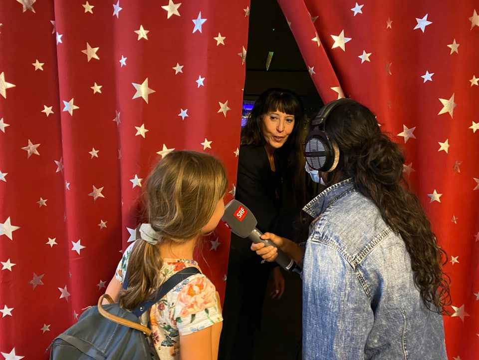 Julia und Rosa-Malena stehen vor dem Vorhang.