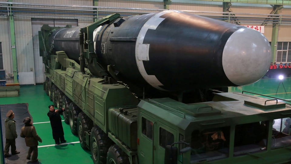 Kim vor einer nordkoreanischen Rakete in einer Fabrik.