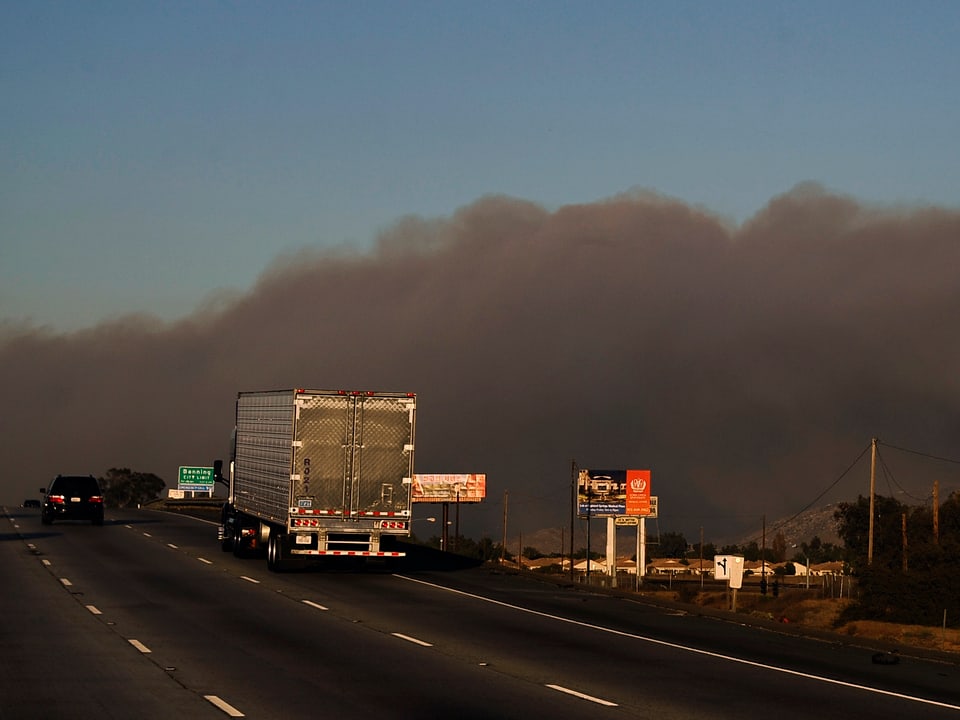 Eine Autobahn im Süden von Kalifornien mit viel Rauch im Hintergrund.