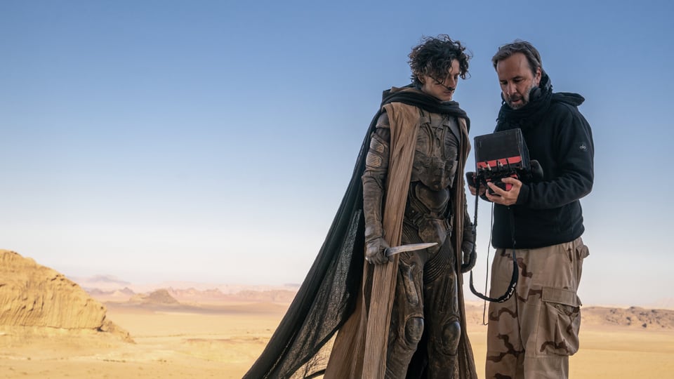 Timothée Chalamet lasst sich auf dem Set mitten in der Wüste von Regisseur Denis Villeneuve instruieren.