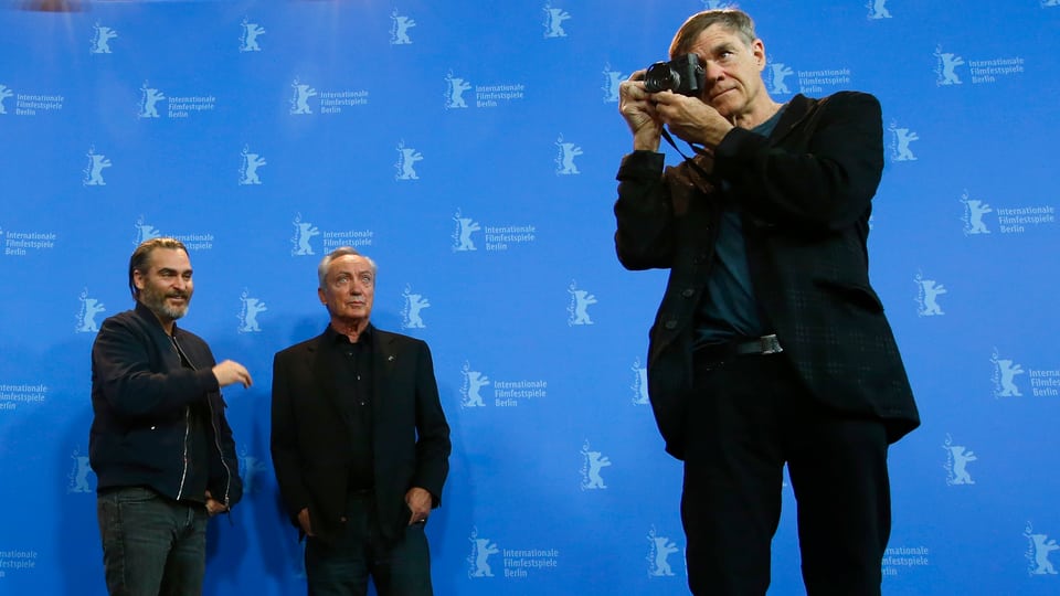 Joaquin Phoenix und Udo Kier im Hintergrund, Gus Van Sant vorne im Blitzlichtgewitter der Berlinale. 