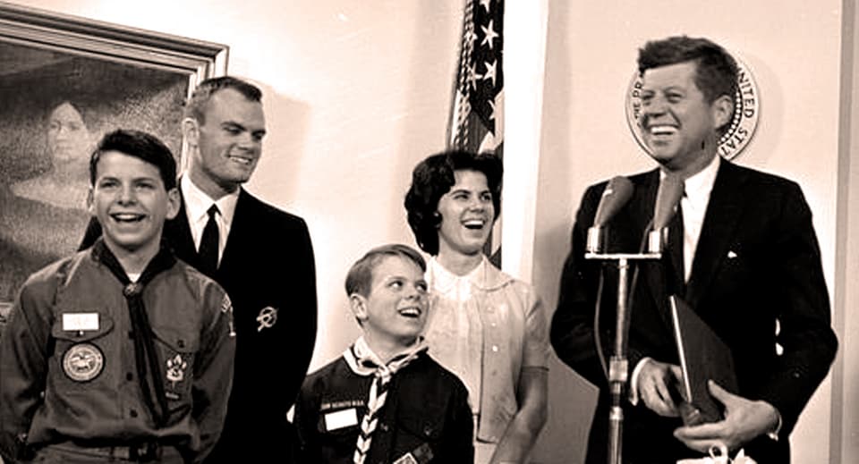 Schwarz/weiss Aufnahme von Kindern in Pfadi Uniform, rechts John F Kennedy