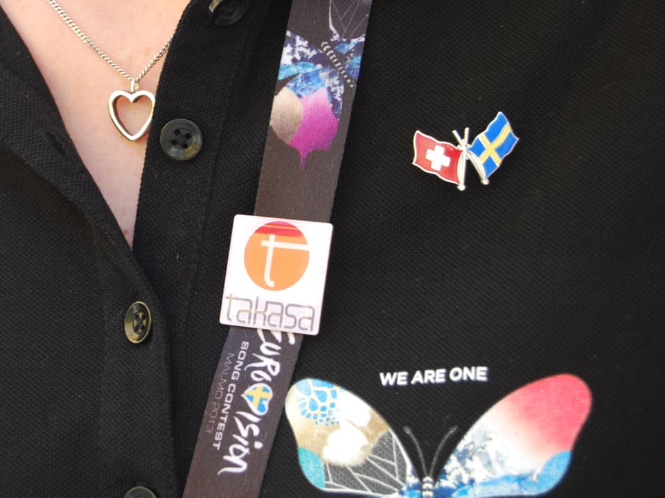 Frida trägt verschiedene Pins zum Eurovision Song Contest am T-Shirt.