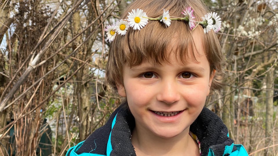 Kind mit Blumenkranz um den Kopf