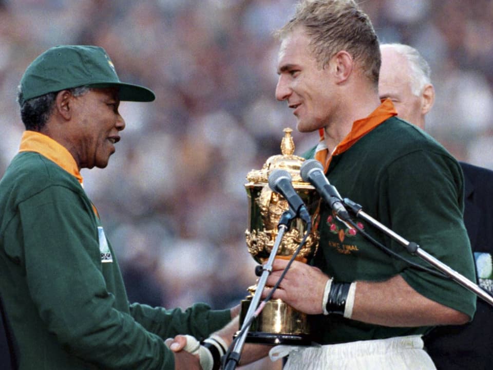 South African President Nelson Mandela congratulates Captain Francois Pienaar on his 1995 World Cup victory.