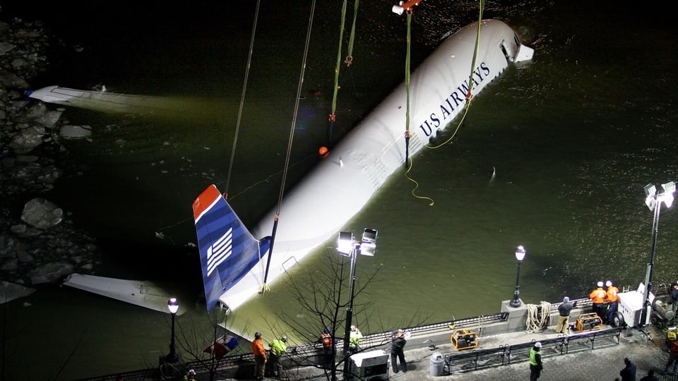 A crane lifts the plane that crashed into the Hudson River out of the water 
