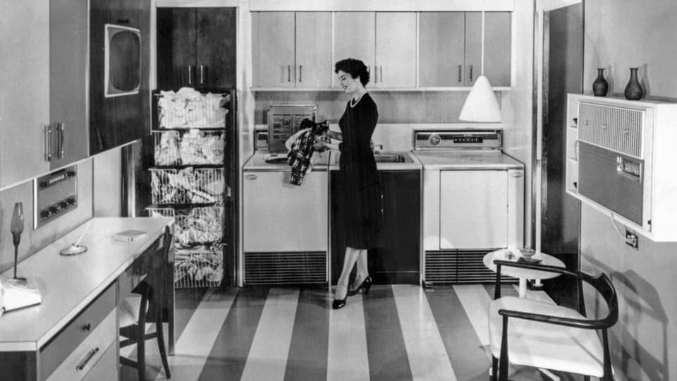 Eine Hausfrau in ihrer für die 1960er-Jahre topmodern ausgestatteten Küche.
