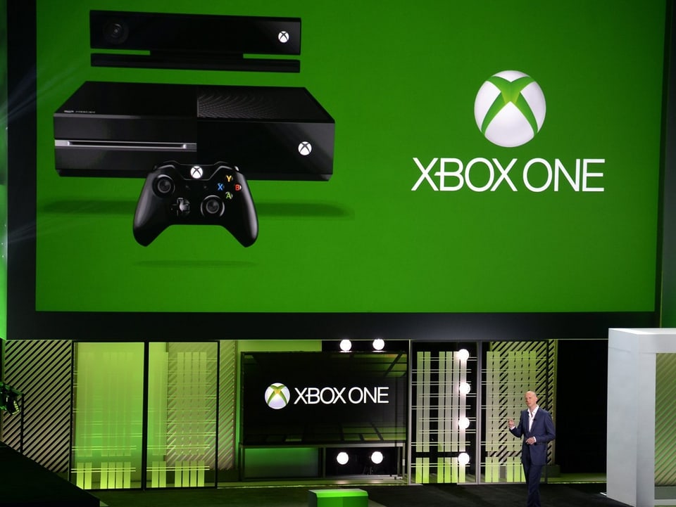 Phil Harrison vor einer grünen Xbox One Folie.