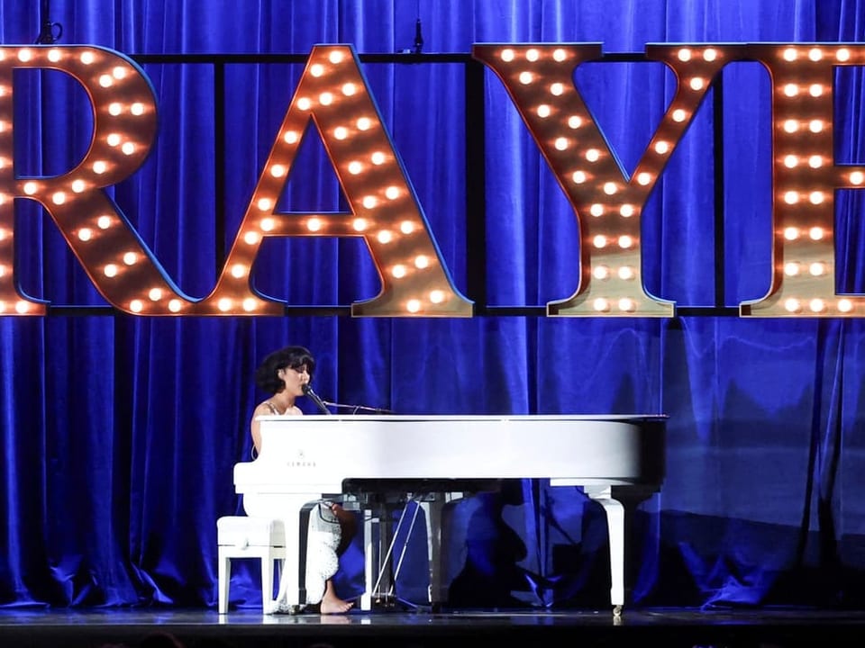 Raye sitzt am Klavier und performt an den Brit Awards.