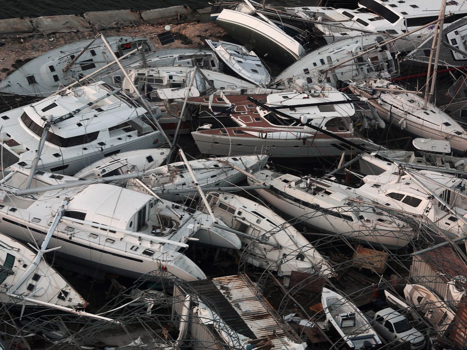 Dutzende von gestrandeten Freizeitbooten und Segelschiffen liegen übereinander gestapelt auf der Karibikinsel Sint Maarten.