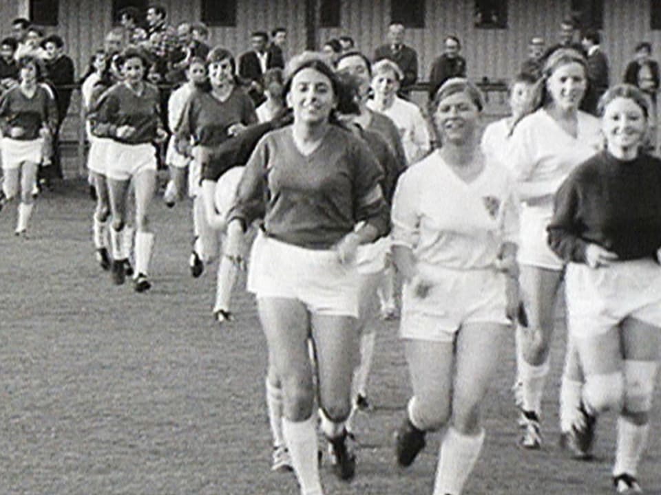 Fussballspielerinnen von 1968 laufen aufs Feld