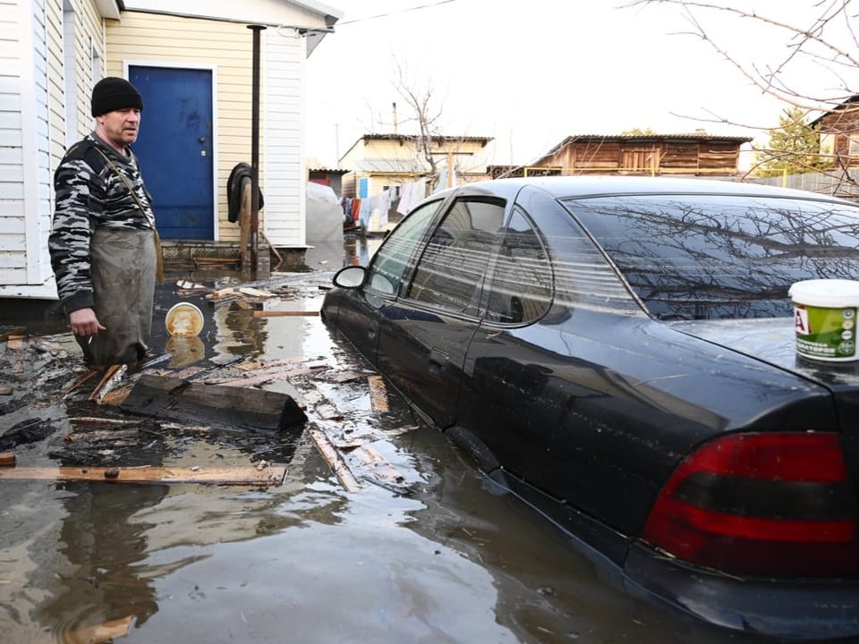 Ein Mann zeigt seinen überfluteten Garten in Orsk.