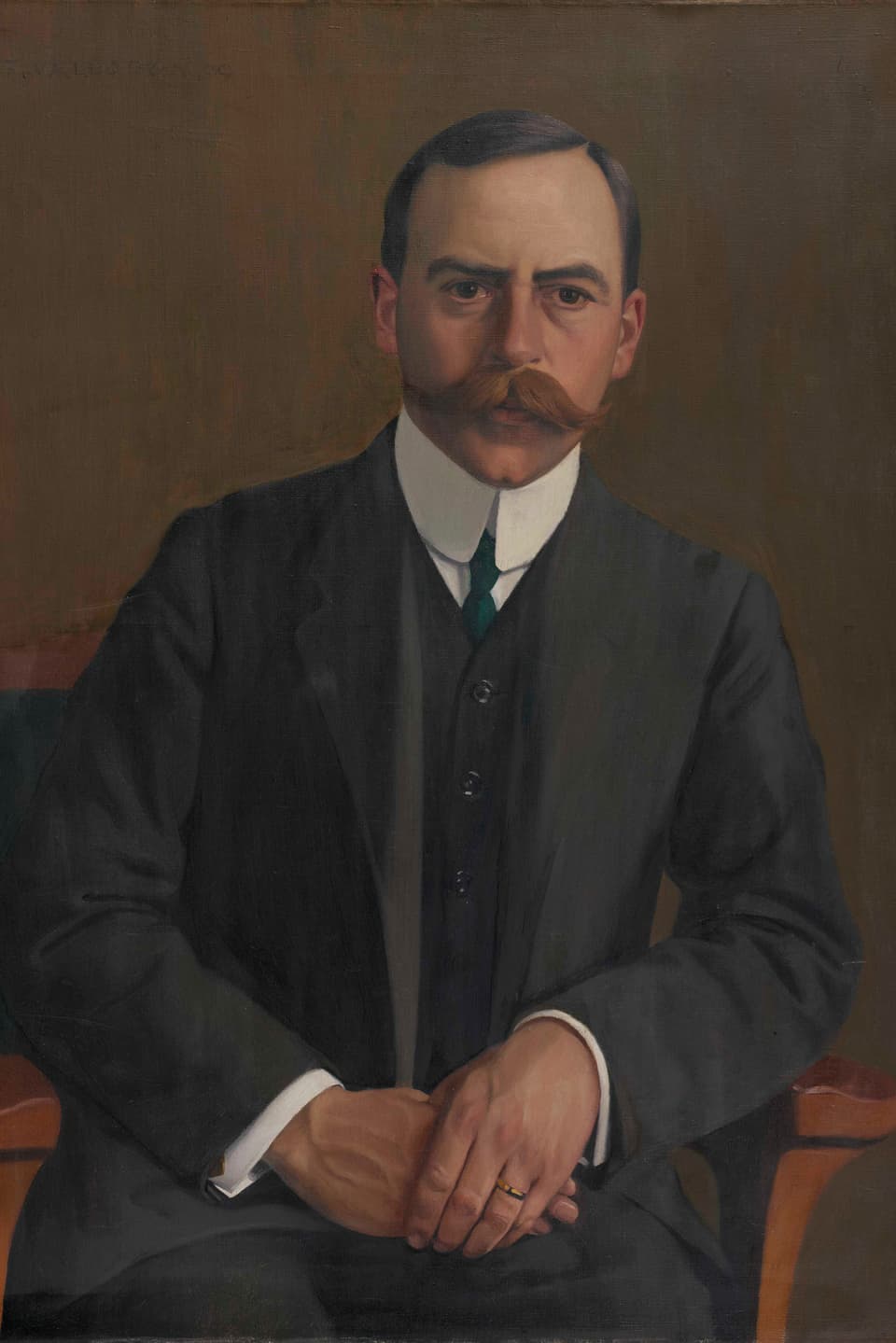 Porträt von Arthur Hahnloser, der Augenarztsitzt auf einem Stuhl, trägt einen Anzug und hält seine Hände auf dem Schoss. 