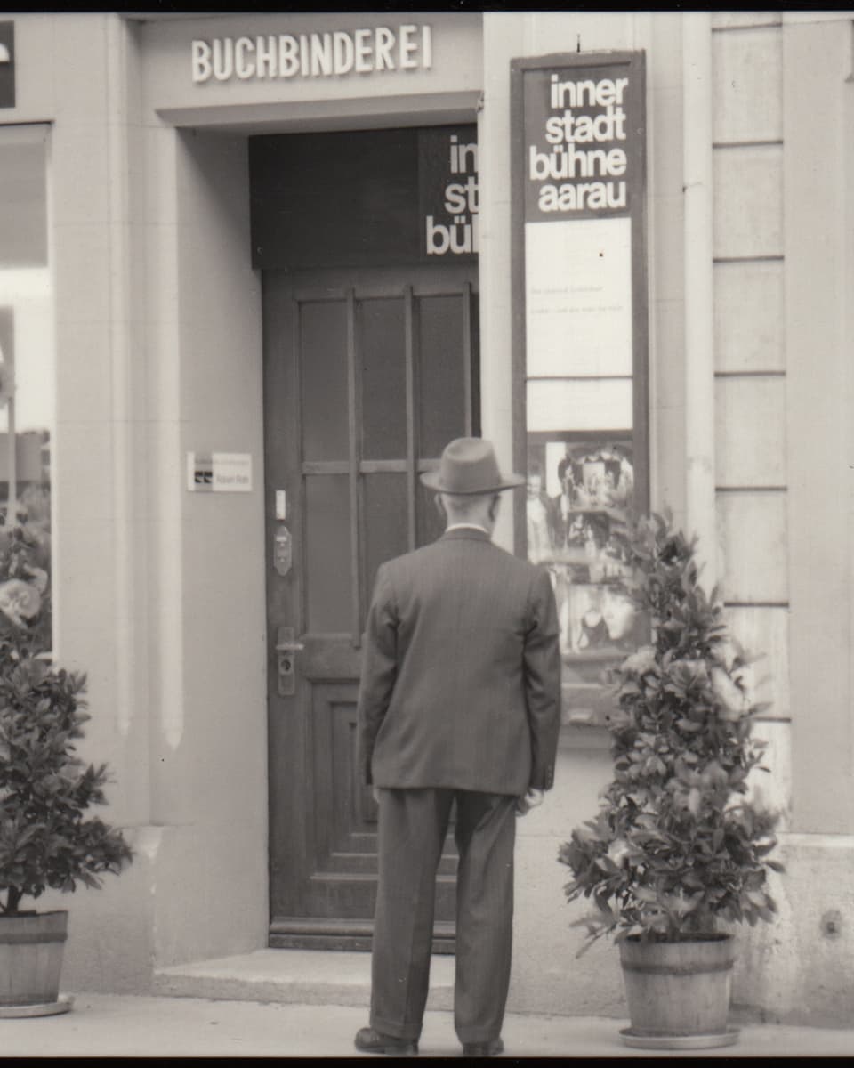 Schwarzweiss Foto: Mann steht vor Eingang