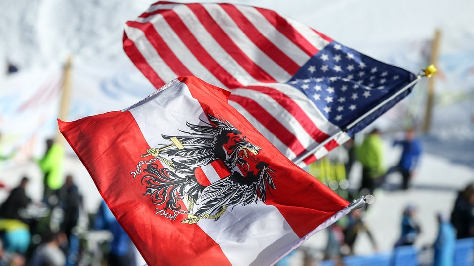 Eine österreichische und US-Flagge werden geschwenkt.