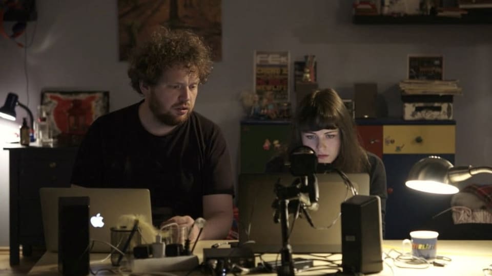The Czech director duo at work in front of their laptops.