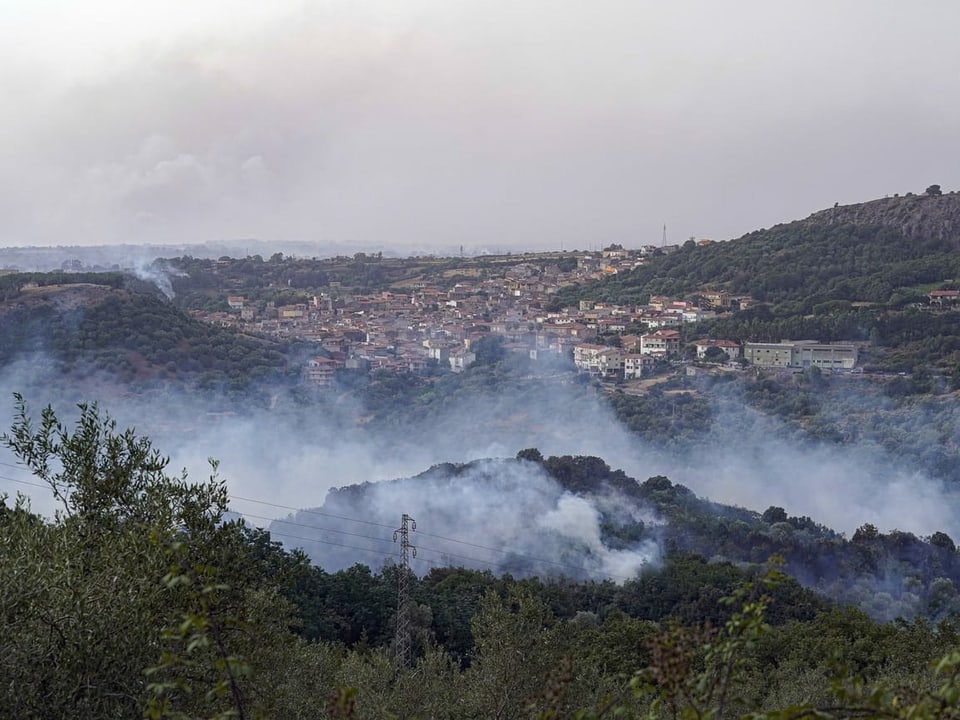 Brandherd vor Dorf im Westen Sardiniens