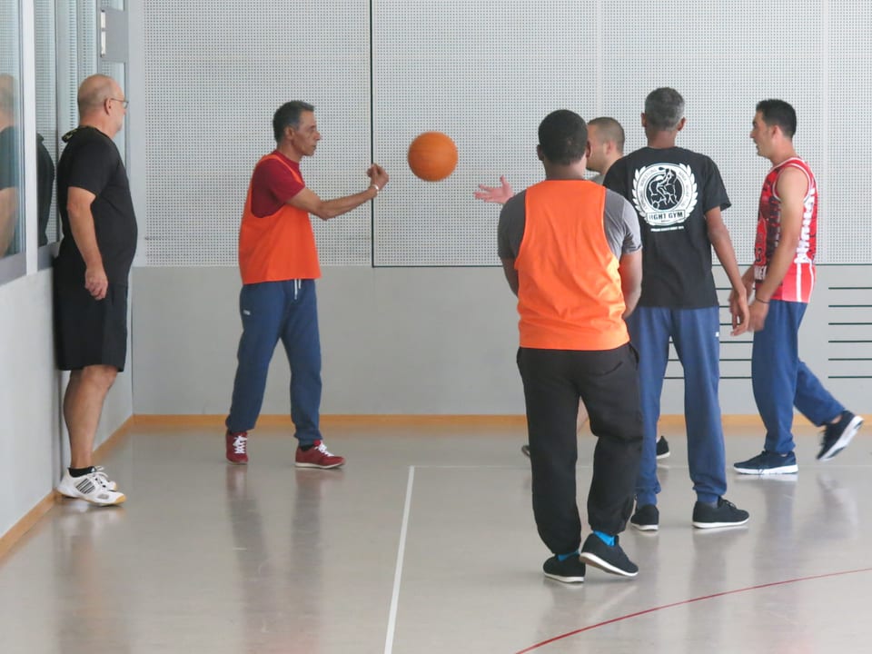 Eine Gruppe Männer spielen mit einem Ball.