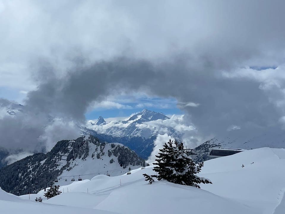 Wolkenreste über verschneiten Gipfeln