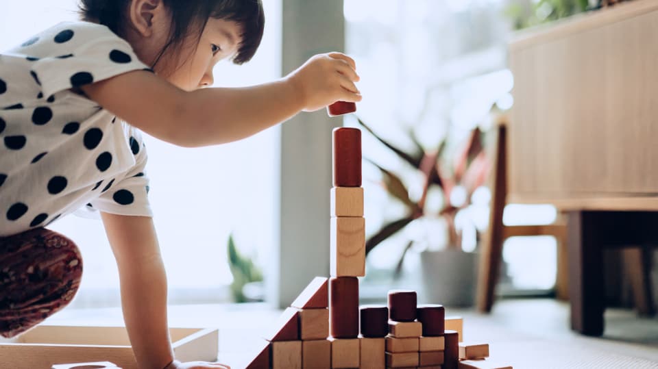 Girl plays with blocks