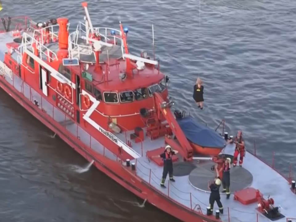 Passagierin wird auf ein rotes Löschschiff abgeseilt.