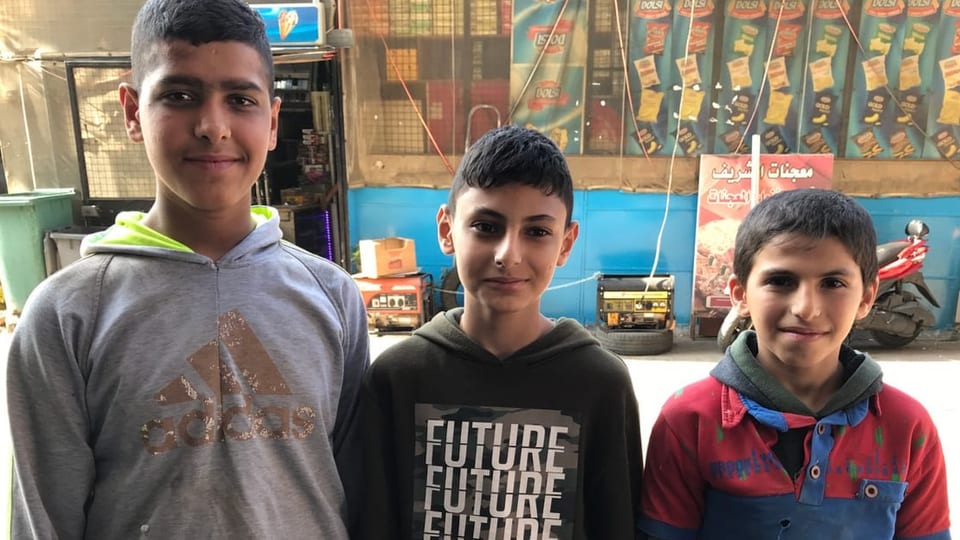 Mohammed, Ahmed und Ibrahim (von rechts) arbeiten auf einem Gemüsemarkt in Tripoli.