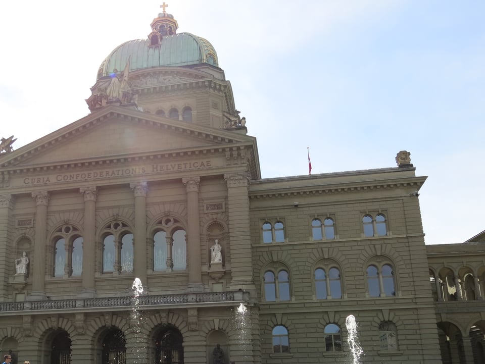 Zu sehen ist das Bundeshaus mit den Springbrunnen auf dem Platz.