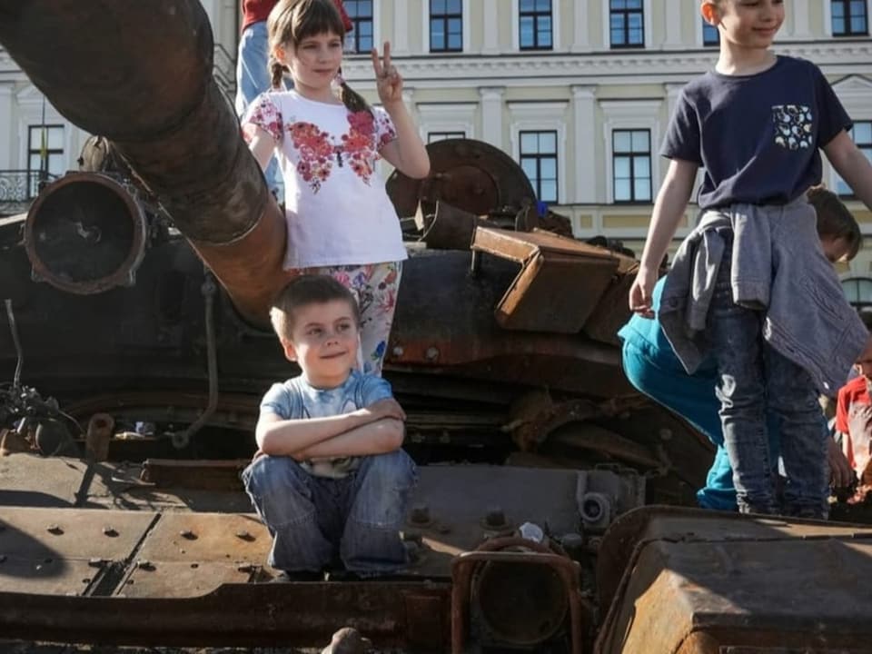 Kinder auf einem russischen Panzer, der auf dem Platz des Heiligen Michael in Kiew ausgestellt wurde (29. Mai).