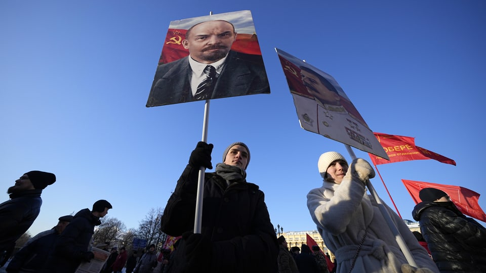 Junge mit Plakat, darauf Lenins Konterfei.