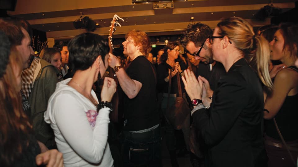 Ed Sheeran badet in der Menge und spielt seine letzte Zugabe umgeben von seinen Fans.