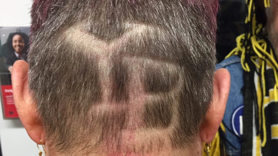 Die Buchstaben YB ins Haar rasiert.