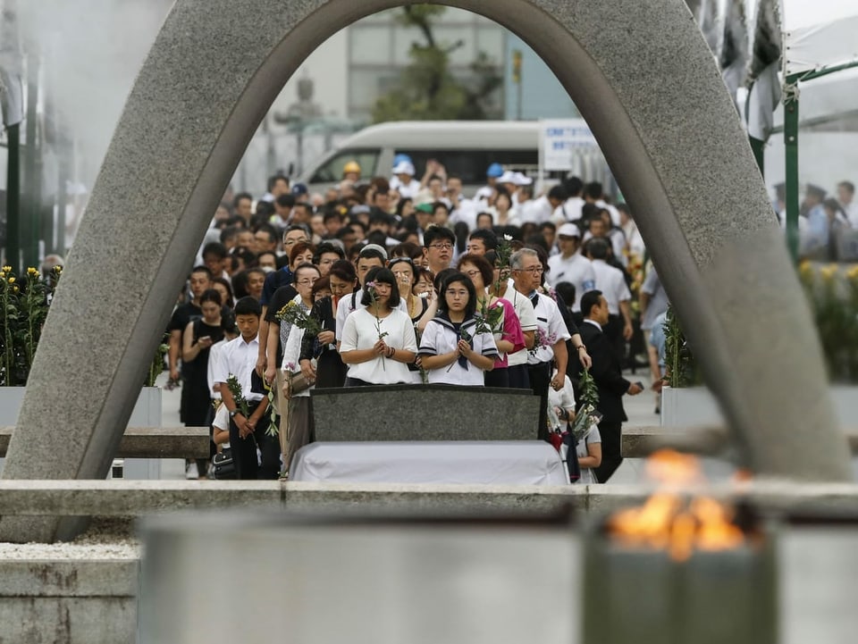 Menschen beten für die Opfer der Atombombe in Hiroshima.