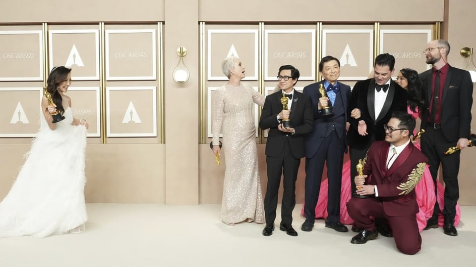 Elegante Schauspielerinnen und Schauspieler posieren jubelnd mit ihren Oscars