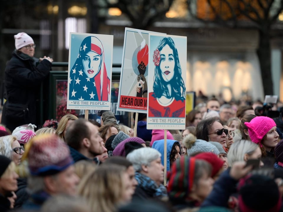 Demonstranten, Plakate von Frauen.