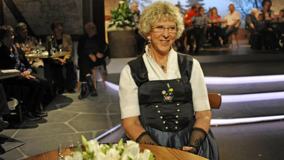 Während TV-Sendung «Potzmusig» am Tisch sitzend.