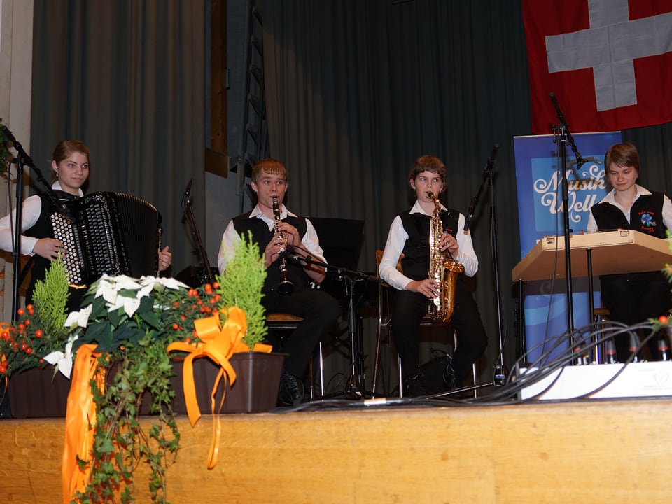 Die vier jungen Musiker im Halbkreis auf der Bühne.