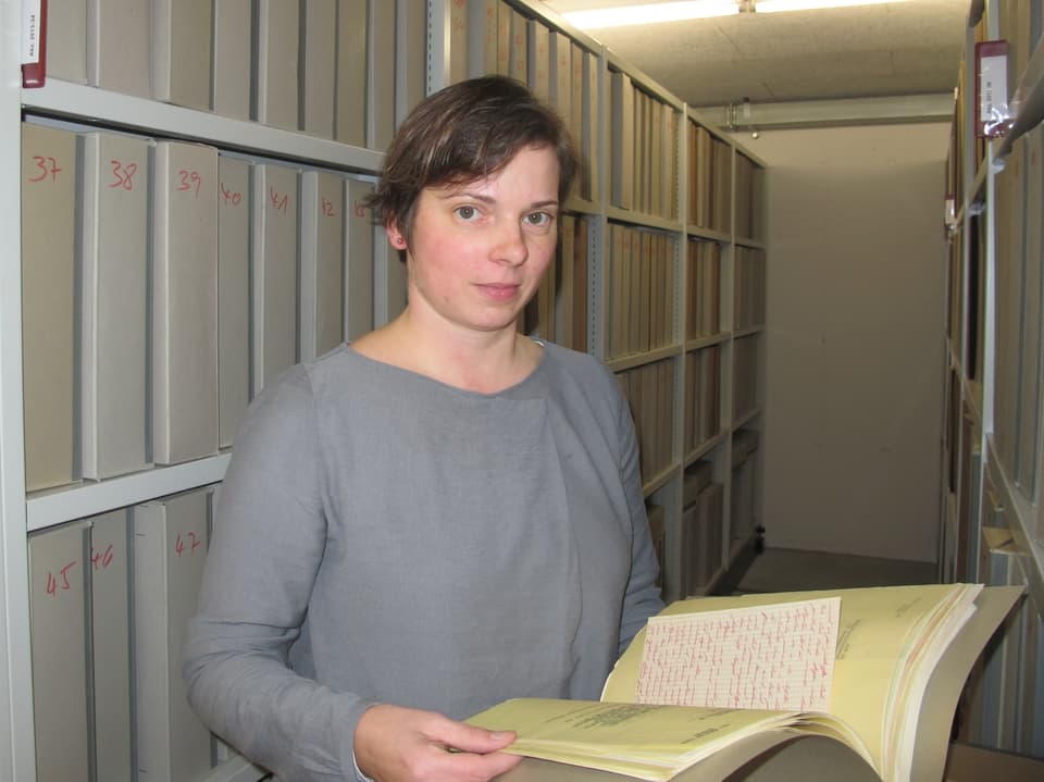 Yvonne Pfäffli zeigt ein altes Buch.