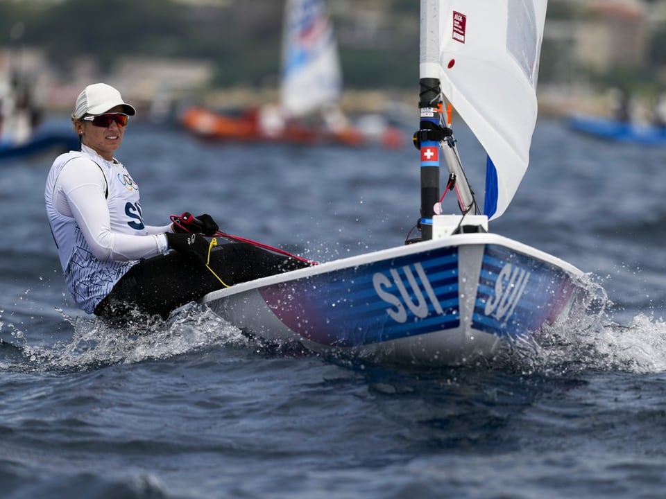 Sailors race on the water.