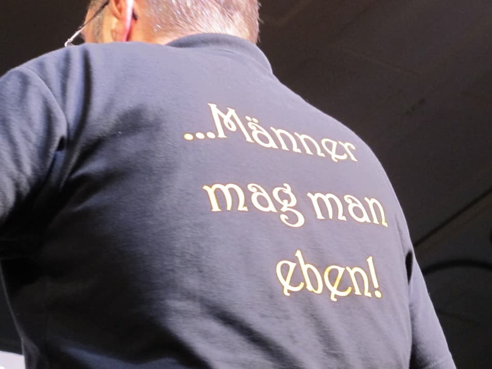 Dirigenten-Rücken mit T-Shirt-Aufschrift: «Männer mag man eben»
