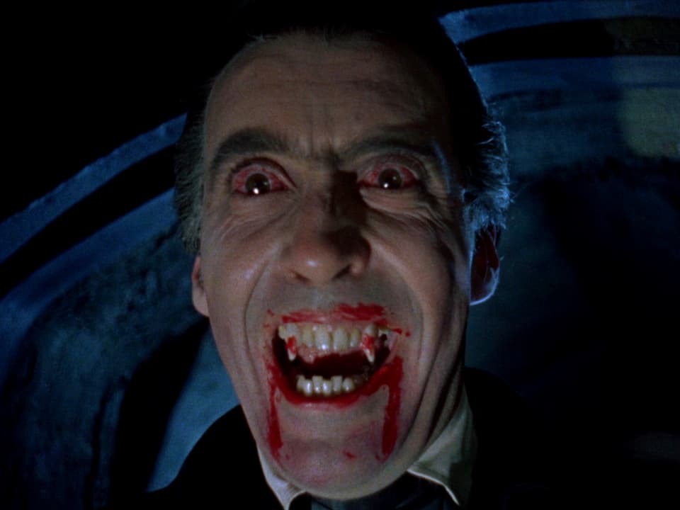 Lee als Dracula mit weit aufgrerissenen Augen und blutverschmiertem Mund.