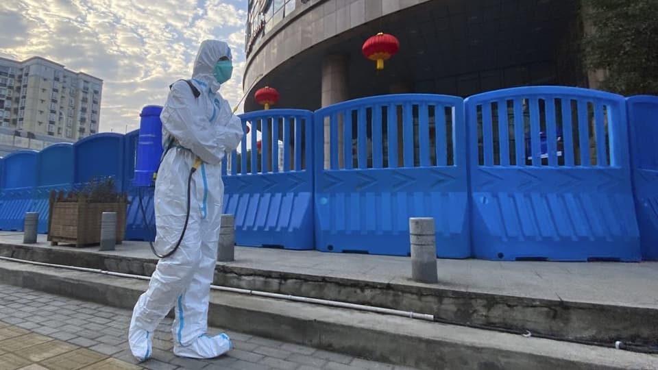 A Chinese health worker outside the hospital in Wuhan.