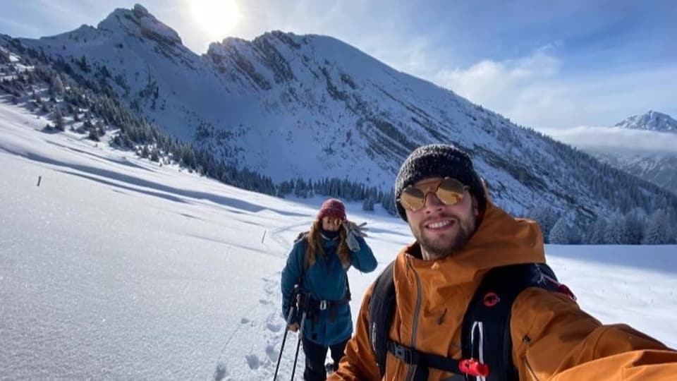 Paar im Schnee vor einem Berg