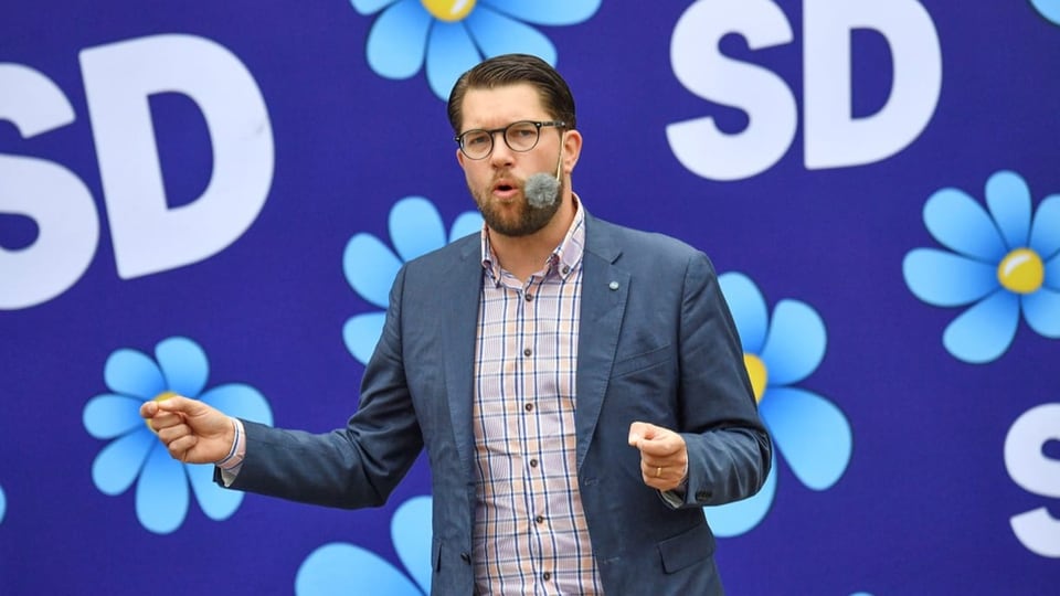 Jimmie Åkesson vor einem Plakat der Schwedendemokraten.