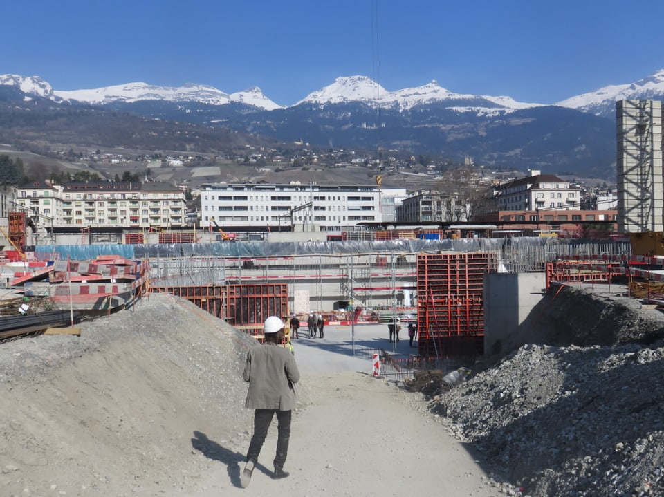 Totale der Baustelle mit Bergen im Hintergrund.