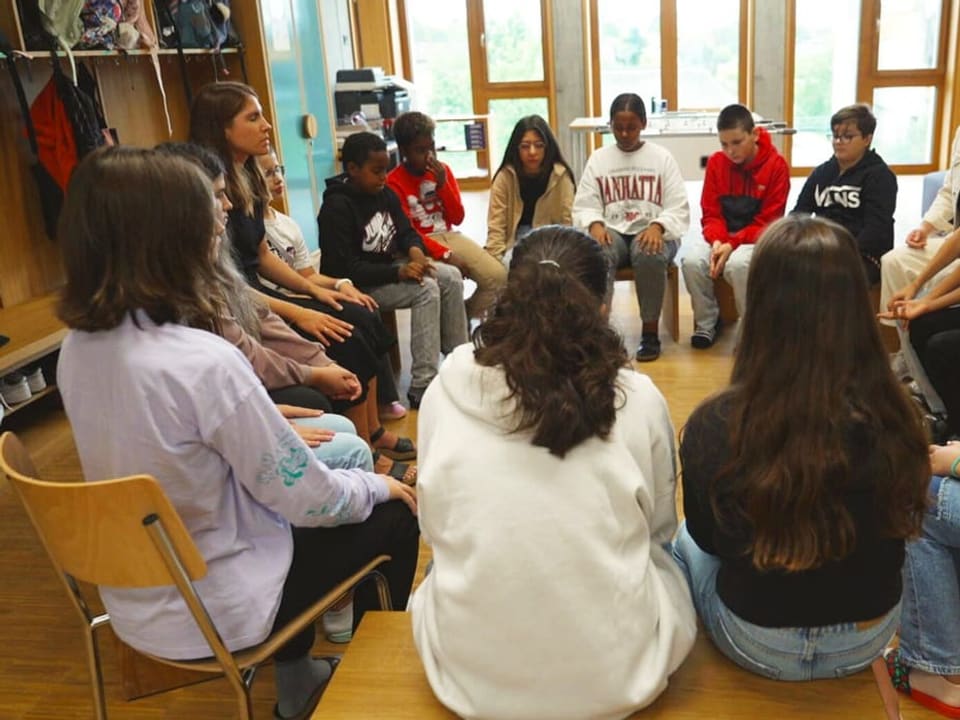 In the picture you can see children in a circle.